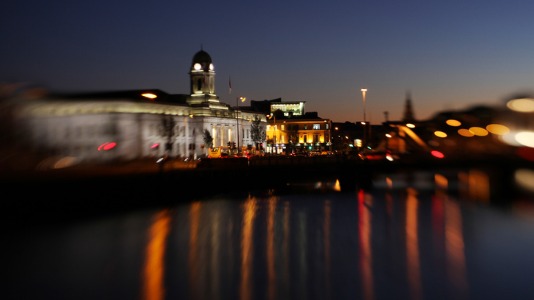 Cork City at night with lights shining on River Lee