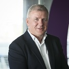 Image of ESB Telecoms Managing Diector, wearing a white shirt and black suit jacket