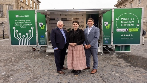 Image of two men and one woman standing in front of a trailer in Trinity College Dubln