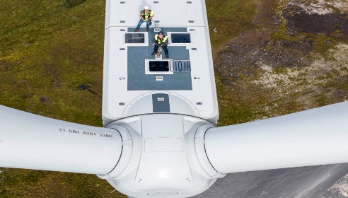 Two engineers standing on top of a wind turbine at Oweninny wind farm