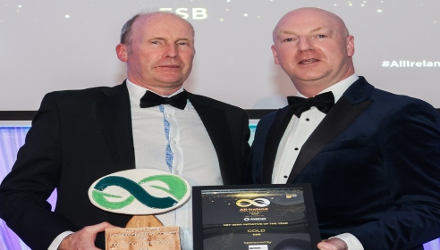 ESB's Ciaran Doran being presented an award plaque from another man at the All Ireland Sustainability Awards