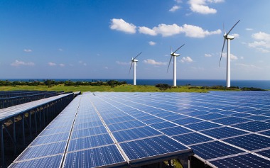 Solar farm with three wind turbines.