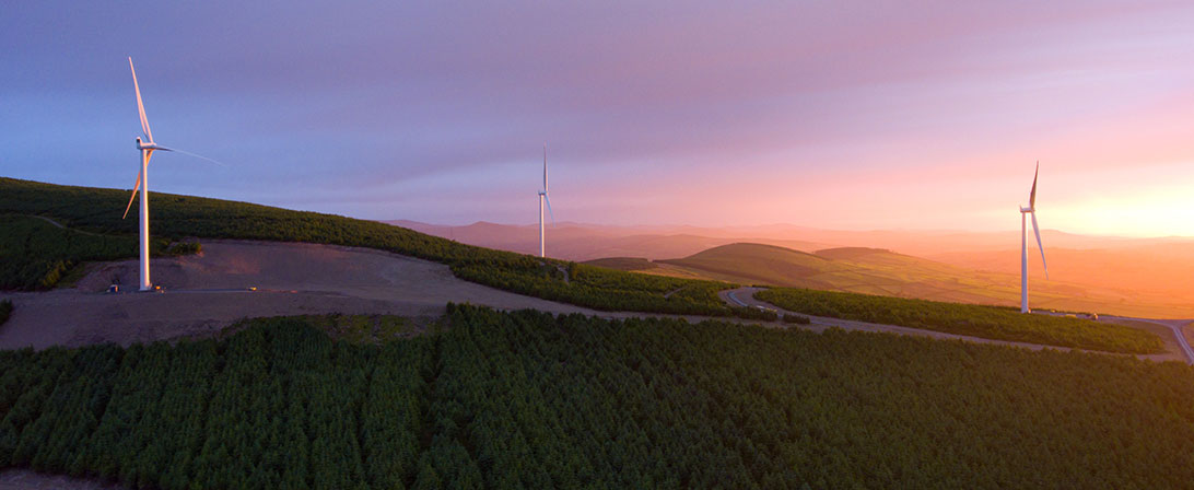 windmills on a hill with sunset